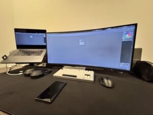 A clean home office setup featuring a laptop connected to an external monitor.