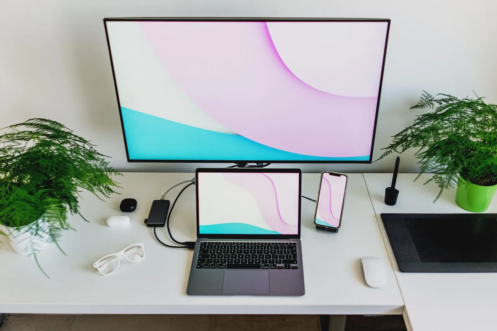 A professional laptop setup connected to a high-resolution external monitor and keyboard.